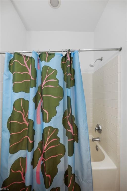 bathroom featuring shower / tub combo with curtain