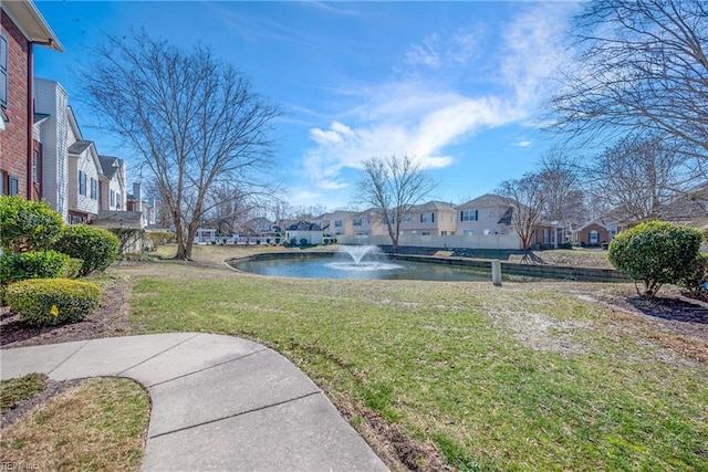 view of yard with a water view and a residential view