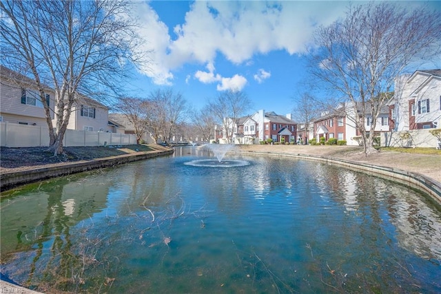 water view featuring fence and a residential view