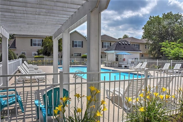 community pool with a patio area, fence, and a pergola