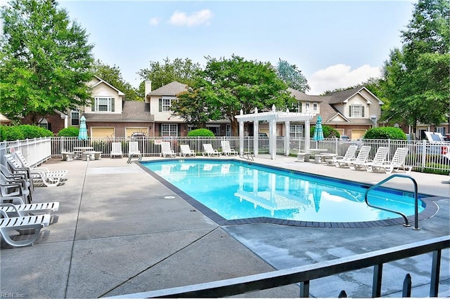 pool featuring fence, a pergola, and a patio