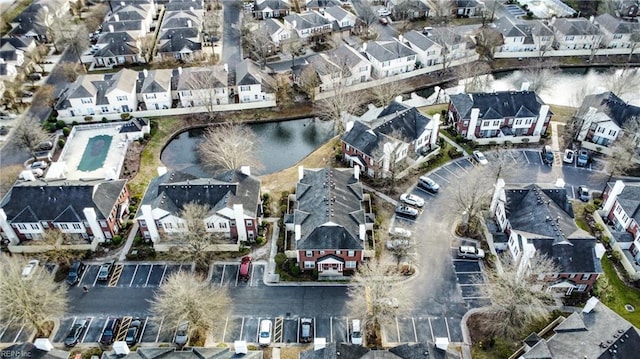 bird's eye view featuring a water view and a residential view