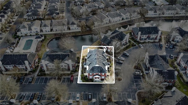 birds eye view of property with a water view and a residential view