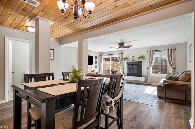 dining room featuring visible vents, dark wood-style flooring, ceiling fan with notable chandelier, and wood ceiling