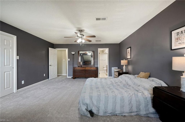 carpeted bedroom with baseboards, visible vents, ceiling fan, and connected bathroom