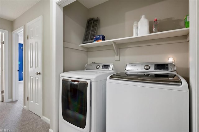 laundry room with laundry area, carpet, baseboards, and washing machine and dryer