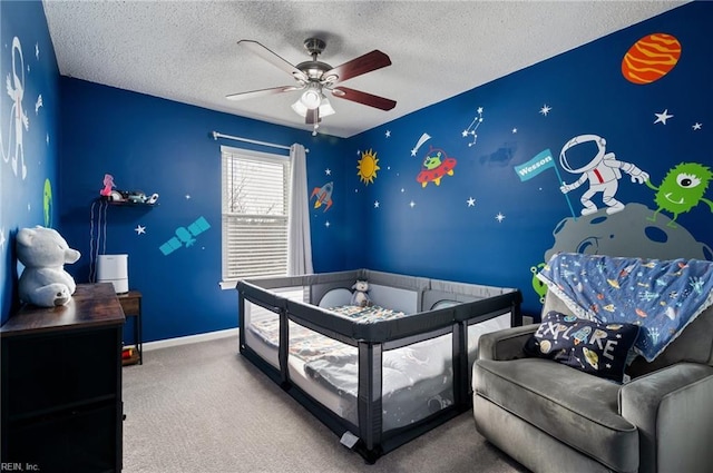 bedroom with ceiling fan, baseboards, a textured ceiling, and carpet flooring