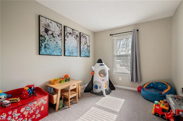 playroom featuring carpet floors, a textured ceiling, and baseboards