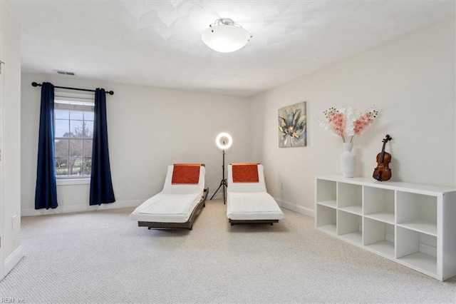 living area featuring carpet floors, visible vents, and baseboards