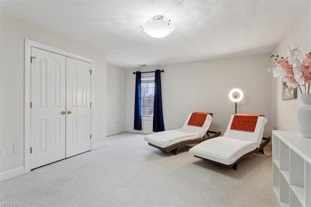 bedroom with carpet, a closet, and baseboards