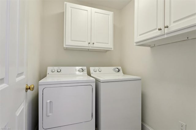 laundry area with cabinet space and independent washer and dryer