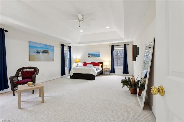 bedroom with a tray ceiling, carpet, recessed lighting, ceiling fan, and baseboards