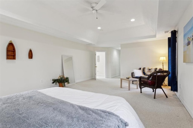 bedroom featuring recessed lighting, a tray ceiling, ceiling fan, and light colored carpet