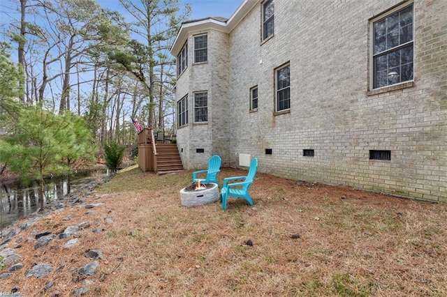 view of yard with a deck, an outdoor fire pit, and stairway