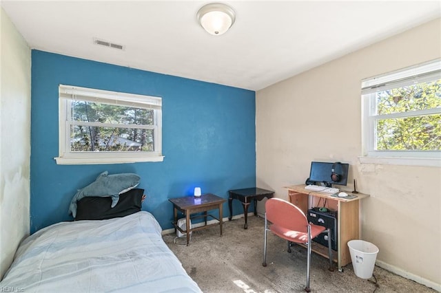 carpeted bedroom with visible vents and baseboards