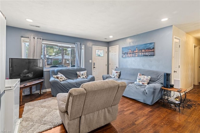 living room with recessed lighting, wood finished floors, visible vents, and baseboards