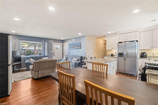 dining space with visible vents, wood finished floors, and recessed lighting