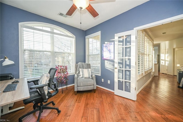 office area featuring hardwood / wood-style floors, visible vents, and a healthy amount of sunlight