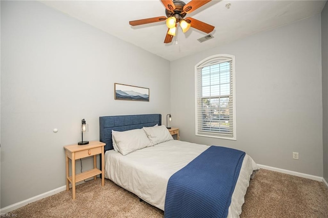 bedroom with baseboards, visible vents, ceiling fan, and light colored carpet