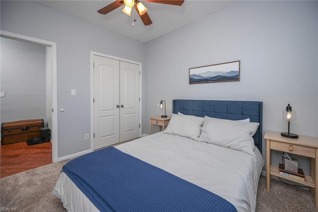 carpeted bedroom with ceiling fan, baseboards, and a closet