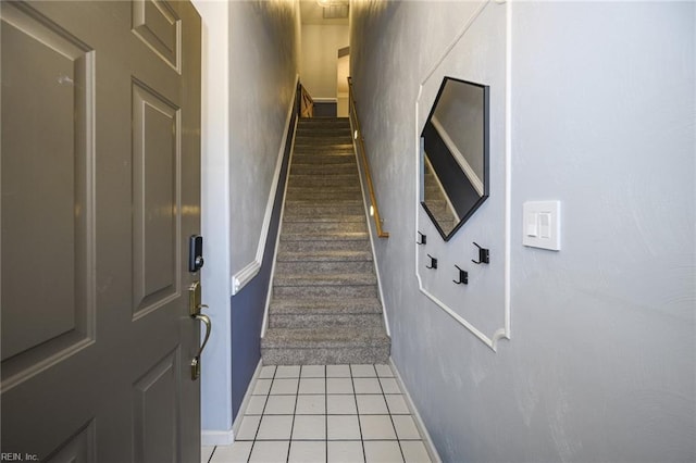 stairs with tile patterned flooring and baseboards