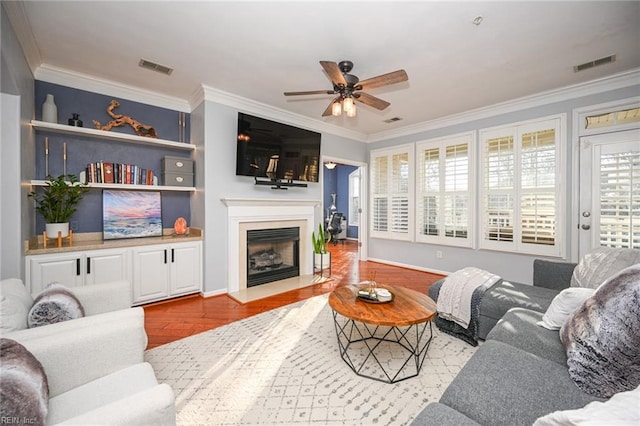 living room with visible vents and crown molding