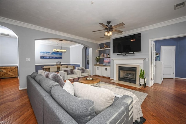 living area with a fireplace with flush hearth, arched walkways, wood-type flooring, and visible vents