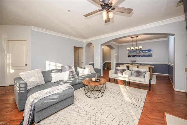 living room featuring ceiling fan with notable chandelier, arched walkways, baseboards, and wood finished floors