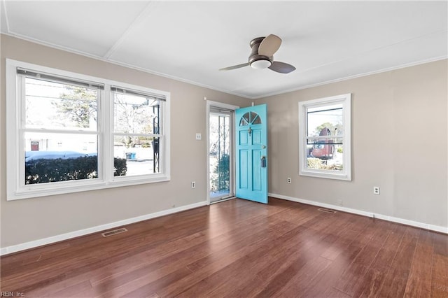 foyer featuring baseboards, visible vents, ceiling fan, wood finished floors, and crown molding