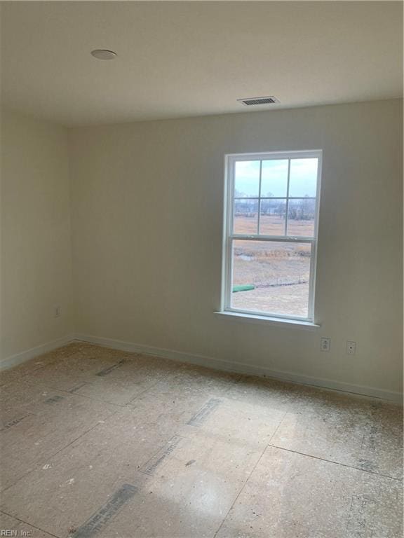 unfurnished room with visible vents and baseboards