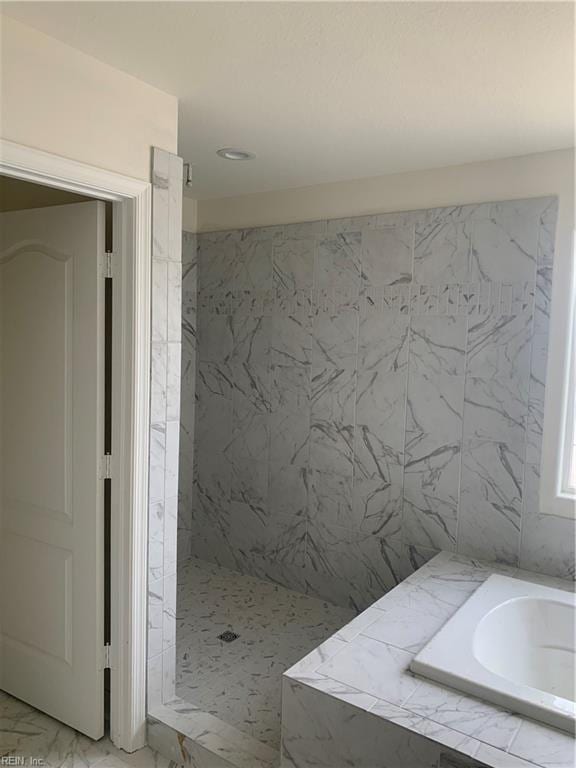 full bath featuring marble finish floor, tiled shower, and a bath