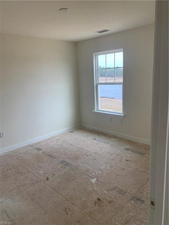 unfurnished room with visible vents and baseboards