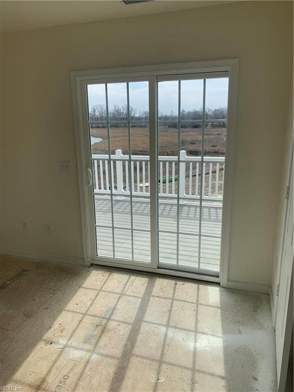 empty room with a healthy amount of sunlight, visible vents, and baseboards