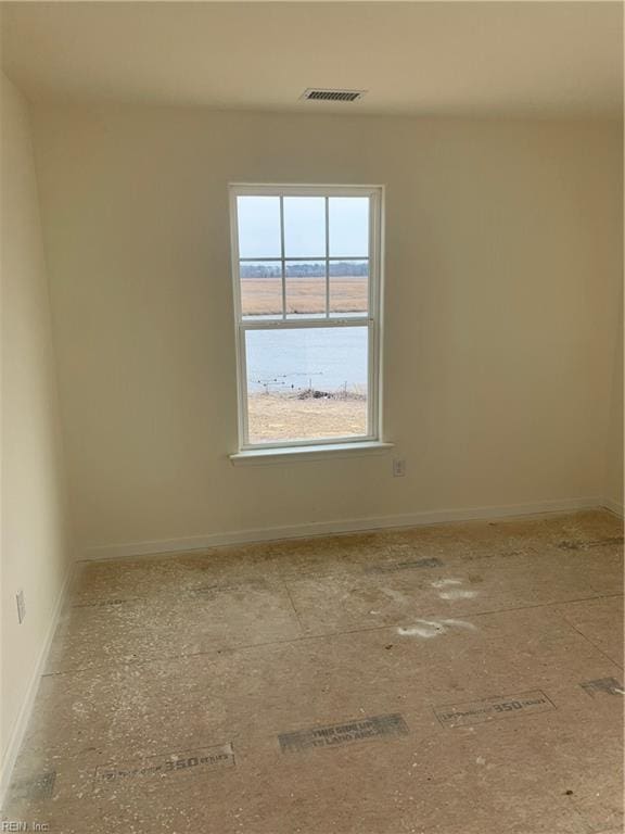 empty room featuring baseboards and visible vents