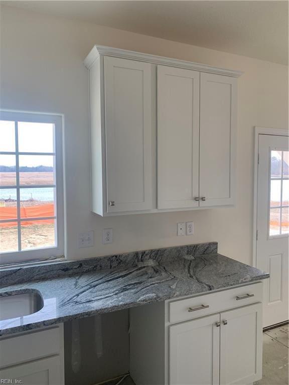 kitchen with a wealth of natural light and white cabinets