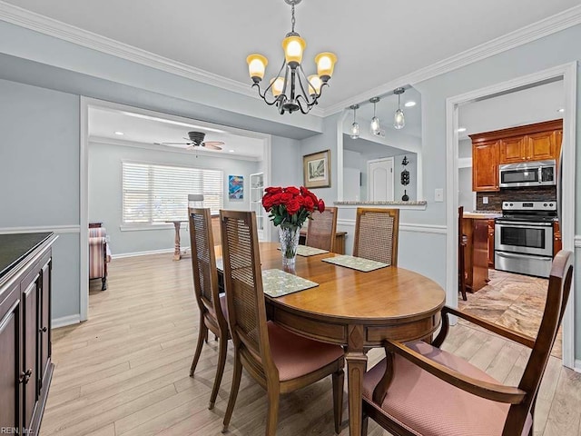 dining space with light wood-style flooring, ornamental molding, baseboards, and ceiling fan with notable chandelier