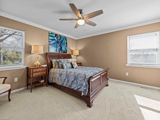 bedroom with ornamental molding, light colored carpet, visible vents, and baseboards