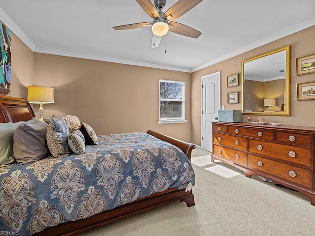 bedroom with carpet floors, ornamental molding, and ceiling fan