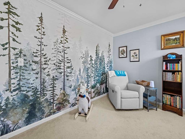 living area with ornamental molding, carpet, a ceiling fan, and baseboards