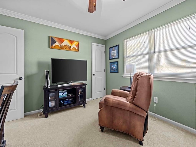 sitting room featuring ceiling fan, carpet floors, ornamental molding, and baseboards