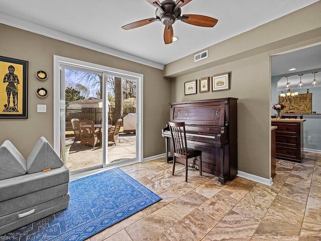 living area with baseboards, ceiling fan with notable chandelier, visible vents, and ornamental molding