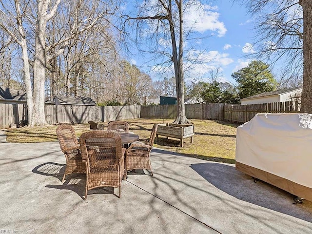 view of patio with a fenced backyard, grilling area, and outdoor dining space