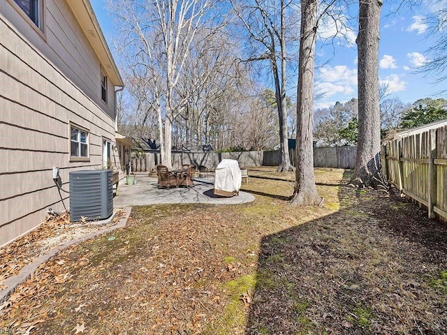 view of yard with a patio area, a fenced backyard, and central AC