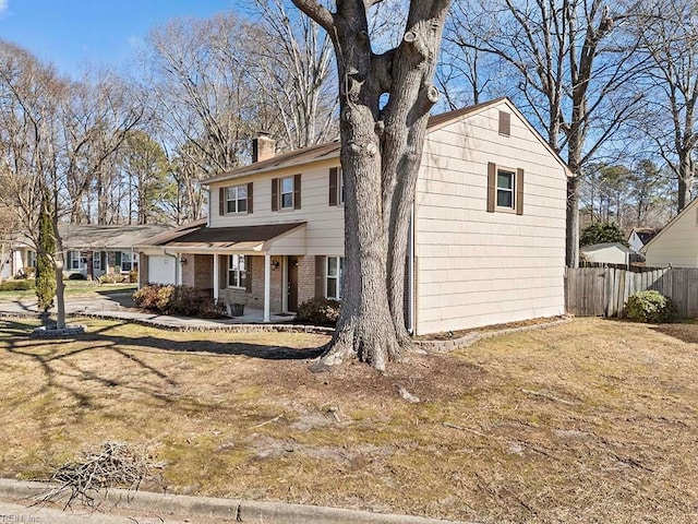 view of front of home featuring brick siding, fence, a chimney, and an attached garage