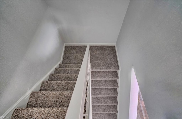 staircase with carpet flooring and baseboards