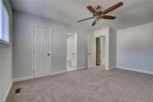 unfurnished bedroom featuring light carpet, a textured ceiling, visible vents, and baseboards