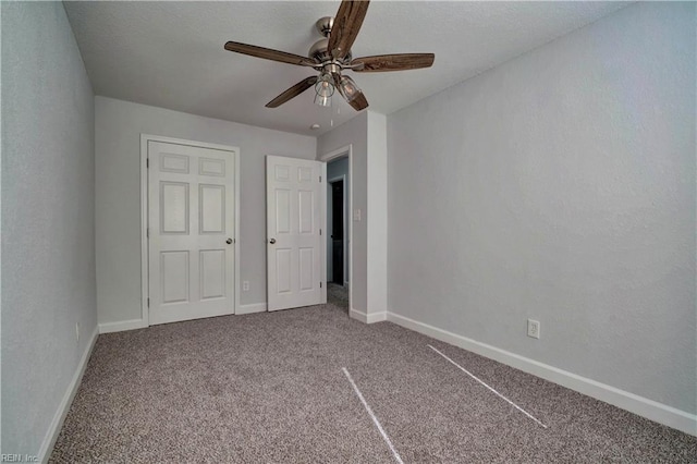 unfurnished bedroom with carpet floors, ceiling fan, and baseboards