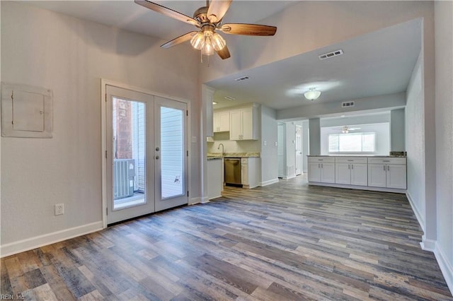 unfurnished living room with french doors, visible vents, electric panel, and wood finished floors