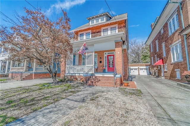 traditional style home with a garage, covered porch, brick siding, and an outdoor structure