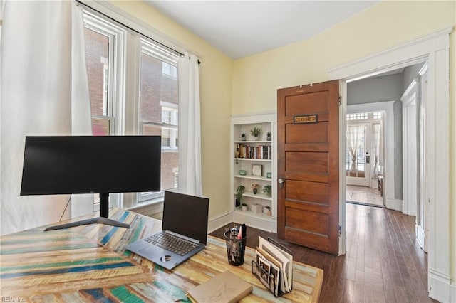 home office with dark wood finished floors and baseboards